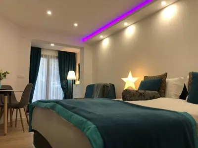 a hotel room with a bed and a purple light at Moonlight Visoko in Visoko