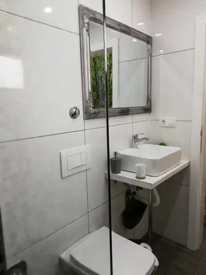 a bathroom with a sink and a toilet and a mirror at Moonlight Visoko in Visoko