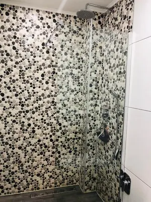 a bathroom with a shower with black and white tiles at Moonlight Visoko in Visoko