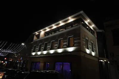 a building with lights on top of it at night at Hotel Rafaelo in Bosanska Dubica