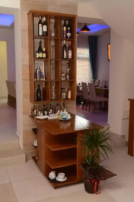 a bar in the middle of a room with wine bottles at Hotel Rafaelo in Bosanska Dubica