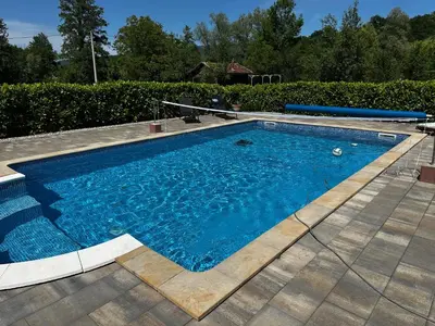 a swimming pool with blue water in a yard at Oasis of peace in Bihać