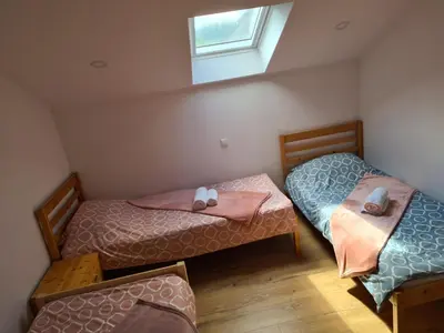 two twin beds in a room with a window at Oasis of peace in Bihać