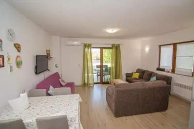 a living room with two couches and a table at Oasis of peace in Bihać