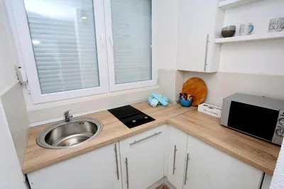 a small kitchen with a sink and a microwave at Apartman City Lux in Banja Luka