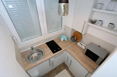 a small kitchen with a sink and a window at Apartman City Lux in Banja Luka