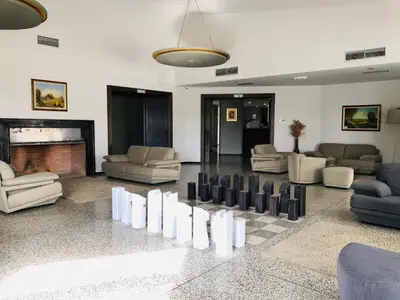 a large living room with couches and a fireplace at Banja Kulaši in Kulaši