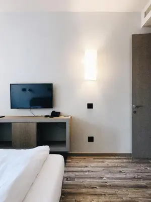 a hotel room with a tv and a bed at Banja Kulaši in Kulaši