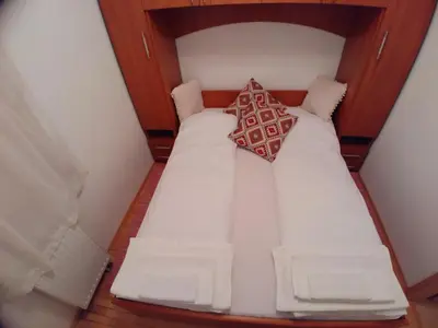 a large white bed in a small room at Apartment Panorama 1 in Vlasic