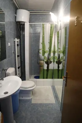 a bathroom with a toilet and a sink and a shower at Sobe-Apartmani Modriča in Modriča