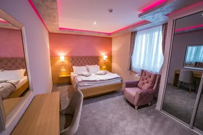 a hotel room with a bed and a chair at Motel Felikitas in Laktaši