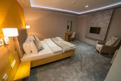 a hotel room with a bed and a couch at Motel Felikitas in Laktaši