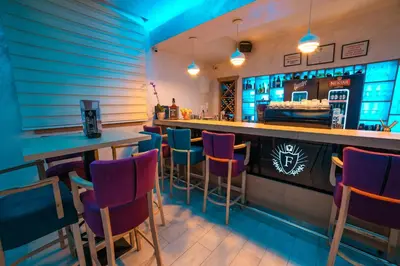 a bar with purple chairs in a restaurant at Motel Felikitas in Laktaši