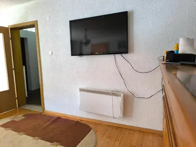 a flat screen tv hanging on a wall at Softa in Travnik