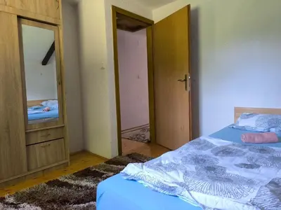 a bedroom with a bed and a dresser and a mirror at Softa in Travnik