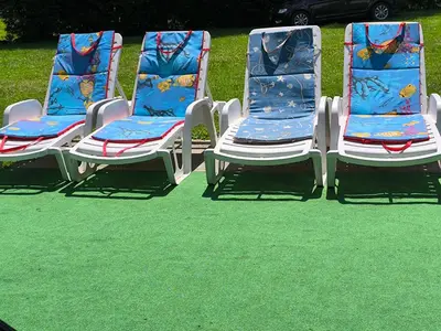 three lawn chairs sitting on top of green grass at Softa in Travnik
