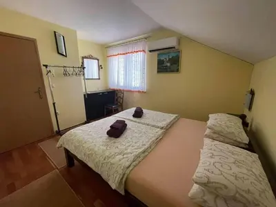 two beds in a small room with two towels on them at ENNI in Bihać