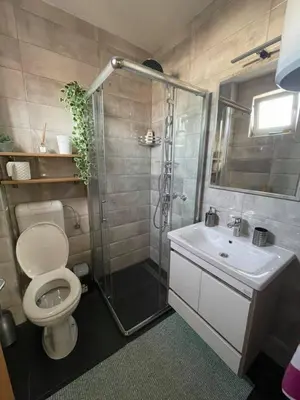 a bathroom with a shower and a toilet and a sink at ENNI in Bihać