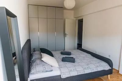 a bedroom with a bed with pillows on it at Apartment Jupiter in Tuzla