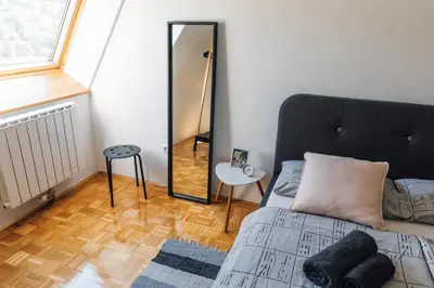 a bedroom with a bed and a mirror at Apartment Jupiter in Tuzla