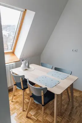 a dining room with a table and chairs at Apartment Jupiter in Tuzla
