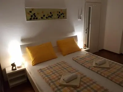 a bedroom with a bed with two pillows on it at Apartman Nena in Banja Luka