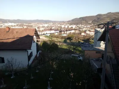 a view of a city with houses and mountains at Apartmani 