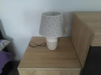 a lamp on top of a wooden table at Apartmani 