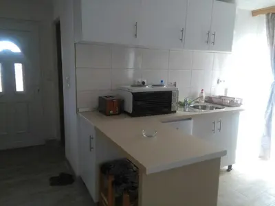 a kitchen with a counter with a microwave and a sink at Apartmani 