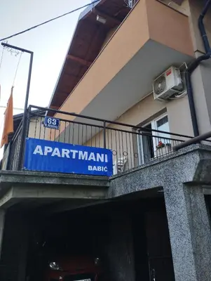 a sign on a balcony of a apartment building at Apartmani 