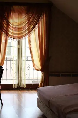 a bedroom with a bed and a large window at Motel Alas in Banja Luka