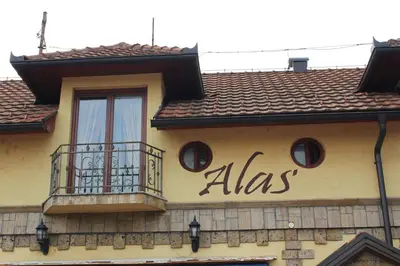 a sign on the side of a building with a balcony at Motel Alas in Banja Luka