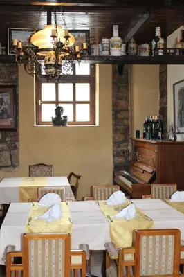 a dining room with white tables and a piano at Motel Alas in Banja Luka