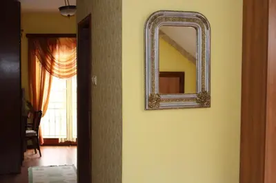 a mirror on a wall next to a hallway at Motel Alas in Banja Luka