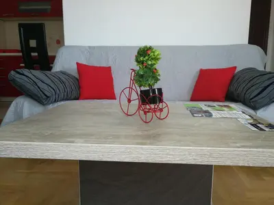 a coffee table with a bike with a plant on it at Good Host in Banja Luka