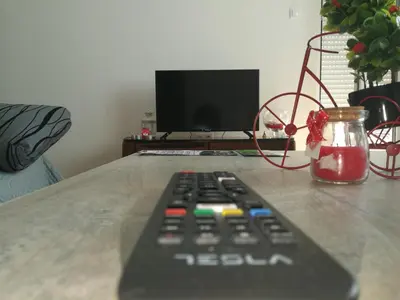 a remote control sitting on top of a table at Good Host in Banja Luka