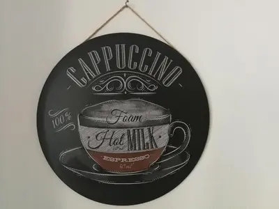 a chalkboard sign with a coffee cup on it at Good Host in Banja Luka