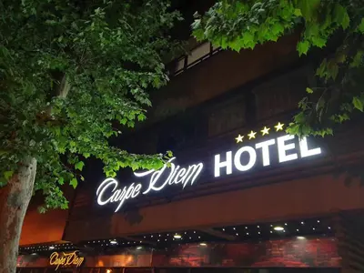a sign for a hotel on the side of a building at Carpe Diem Boutique Hotel in Zenica