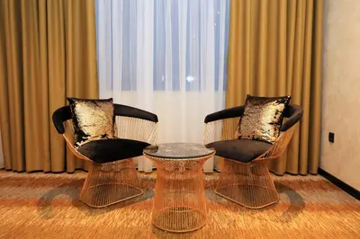 two chairs and a table in front of a window at Carpe Diem Boutique Hotel in Zenica
