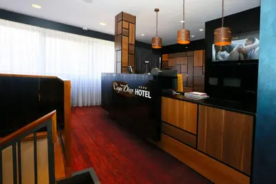 a hotel lobby with a tv and a bar at Carpe Diem Boutique Hotel in Zenica