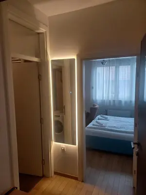 a room with a bedroom with a bed and a window at NM Apartman in Banja Luka