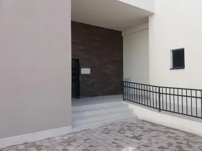 a hallway of a building with a door and stairs at NM Apartman in Banja Luka