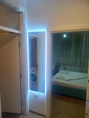 a room with a bathroom with a bed and a mirror at NM Apartman in Banja Luka
