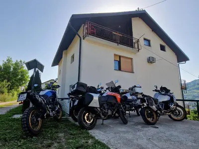 a group of motorcycles parked in front of a house at Horizont apartmans in Jajce