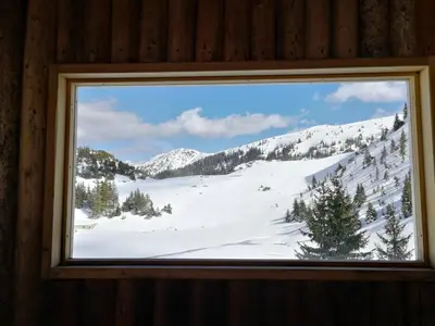 a window with a view of a snow covered mountain at Koliba - Prokoško jezero in Fojnica