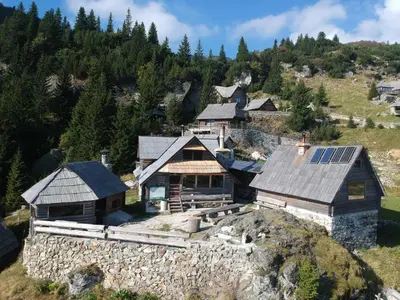 an aerial view of a house with solar panels on its roof at Koliba - Prokoško jezero in Fojnica