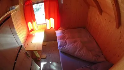 an overhead view of a bed in a room with a window at Koliba - Prokoško jezero in Fojnica