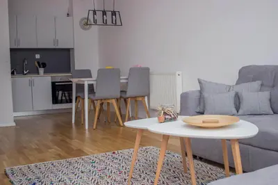 a living room with a couch and a table at City Break Apartment in Visoko
