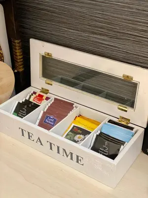 a white drawer filled with books on a table at City Break Apartment in Visoko