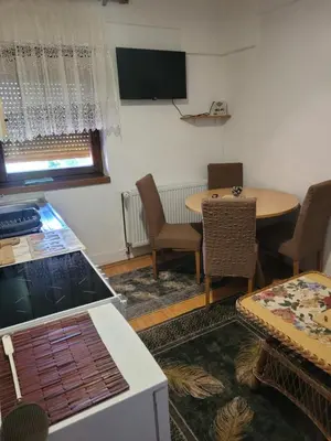 a kitchen and dining room with a table and chairs at Apartman View Una in Bihać